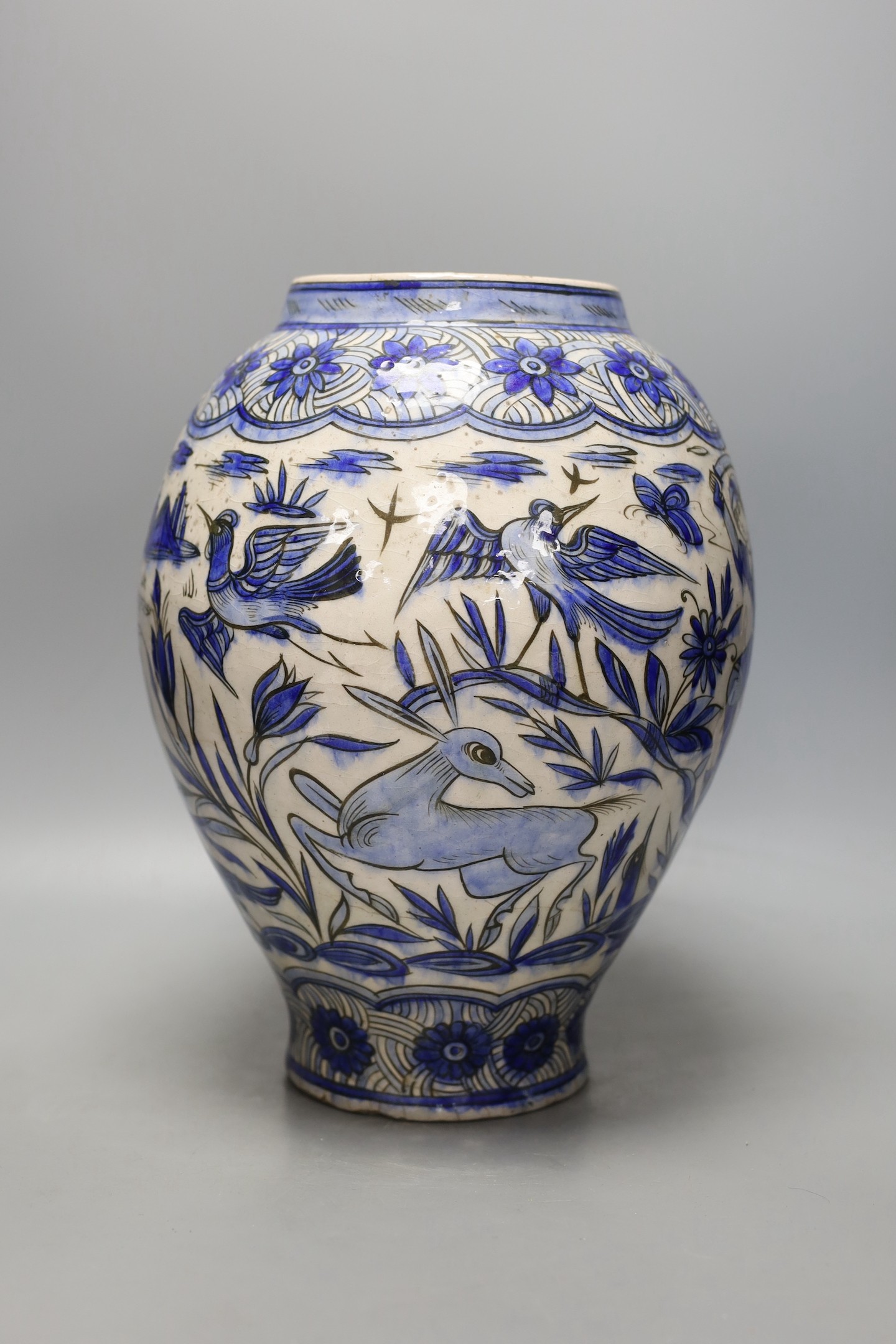 A large Persian pottery jar ‘hunting scene’ jar, Safavid style, 19th century, 33cm